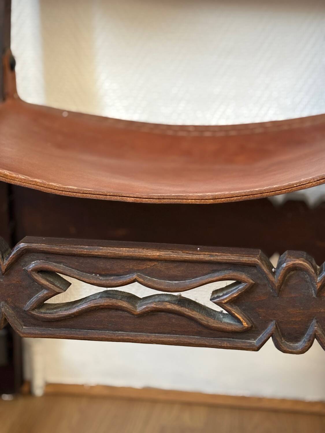 Frailero armchair, antique Spanish — carved wood & full-grain leather.