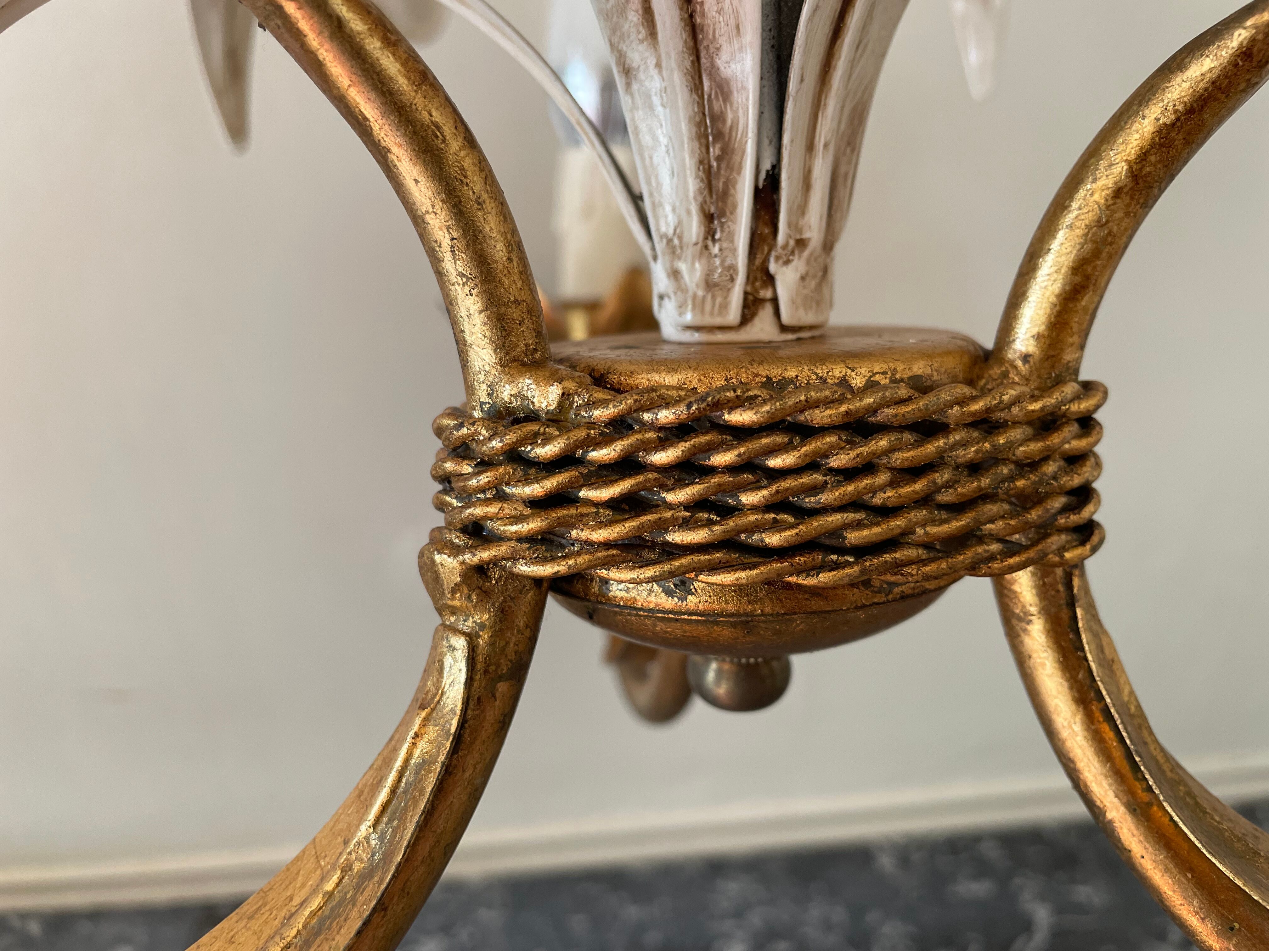 Golden metal chandelier decorated with flowers