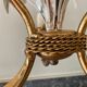 Golden metal chandelier decorated with flowers