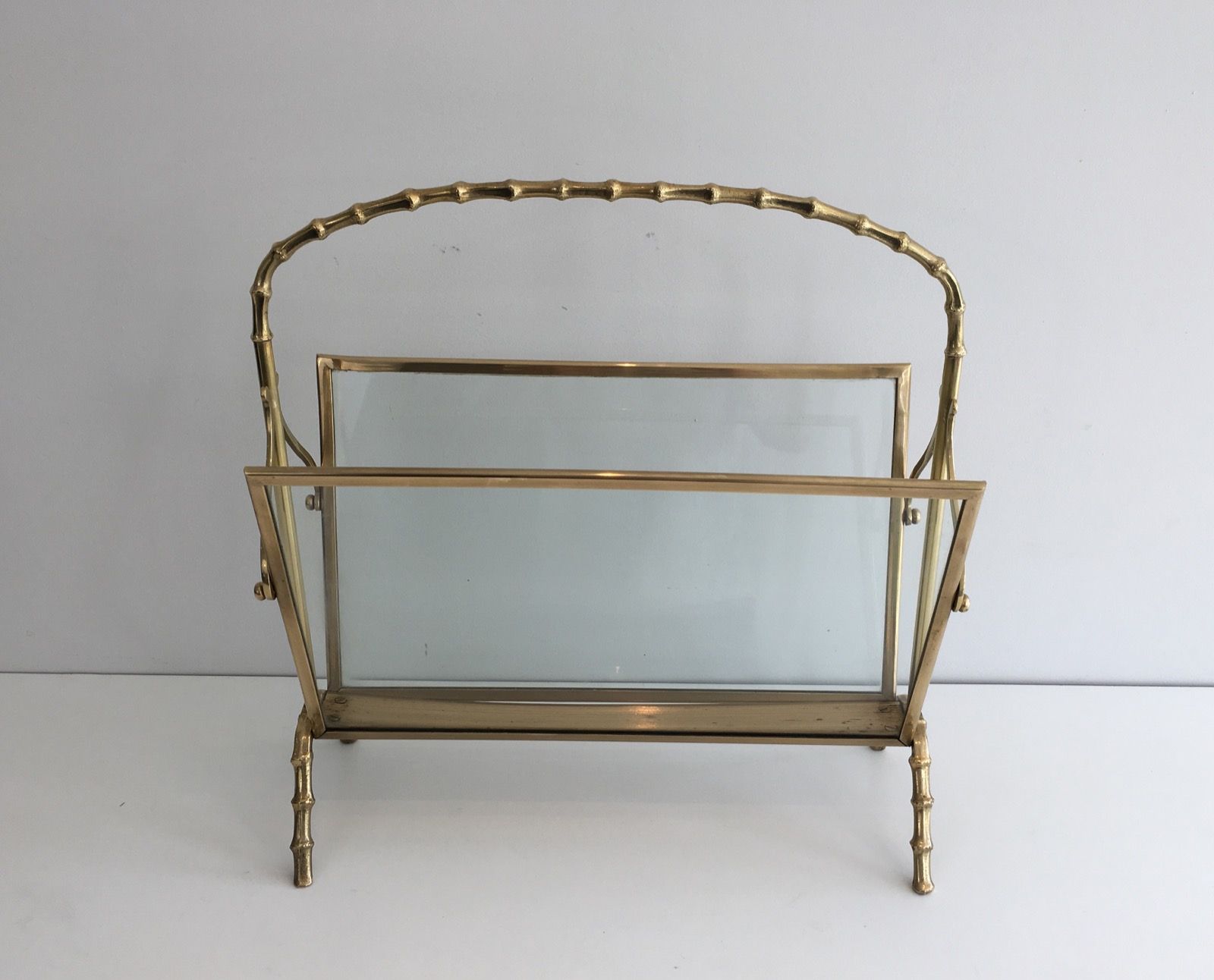 Bamboo-style brass magazine rack from the Baguès house.