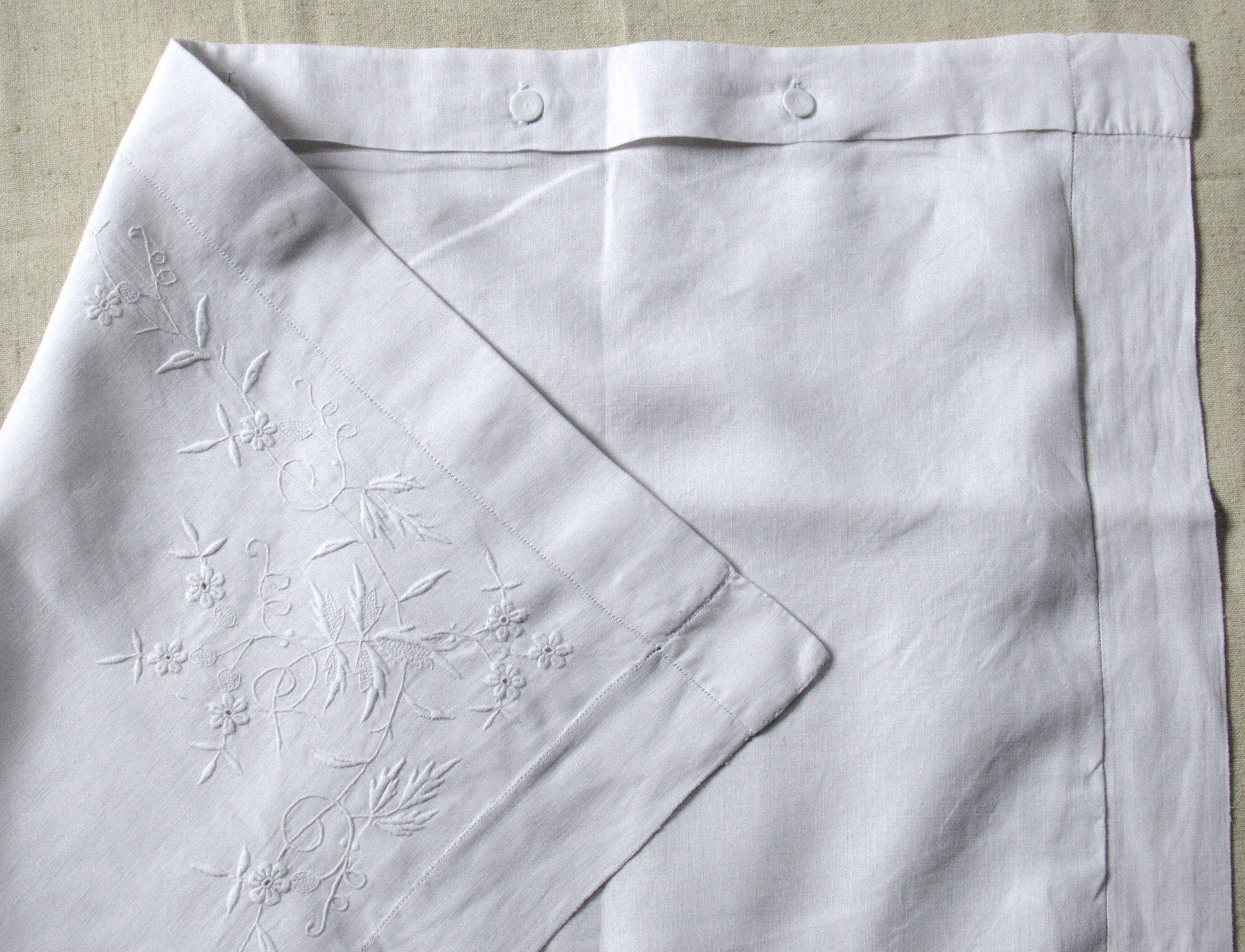 old pillowcase embroidered with fine flowers, marked MP, 19th