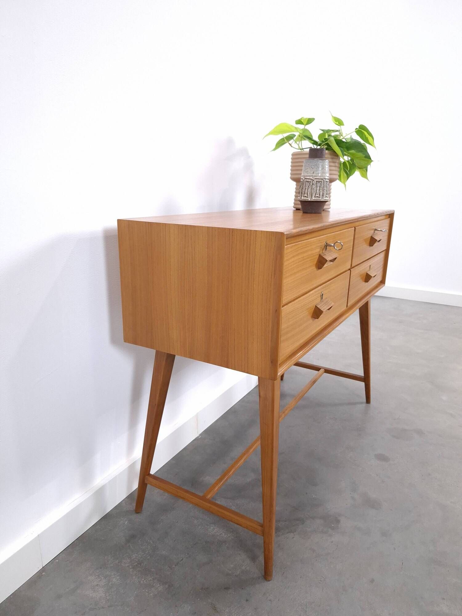 Vintage teak Danish chest of drawers with high slanted legs, side table, sideboard.