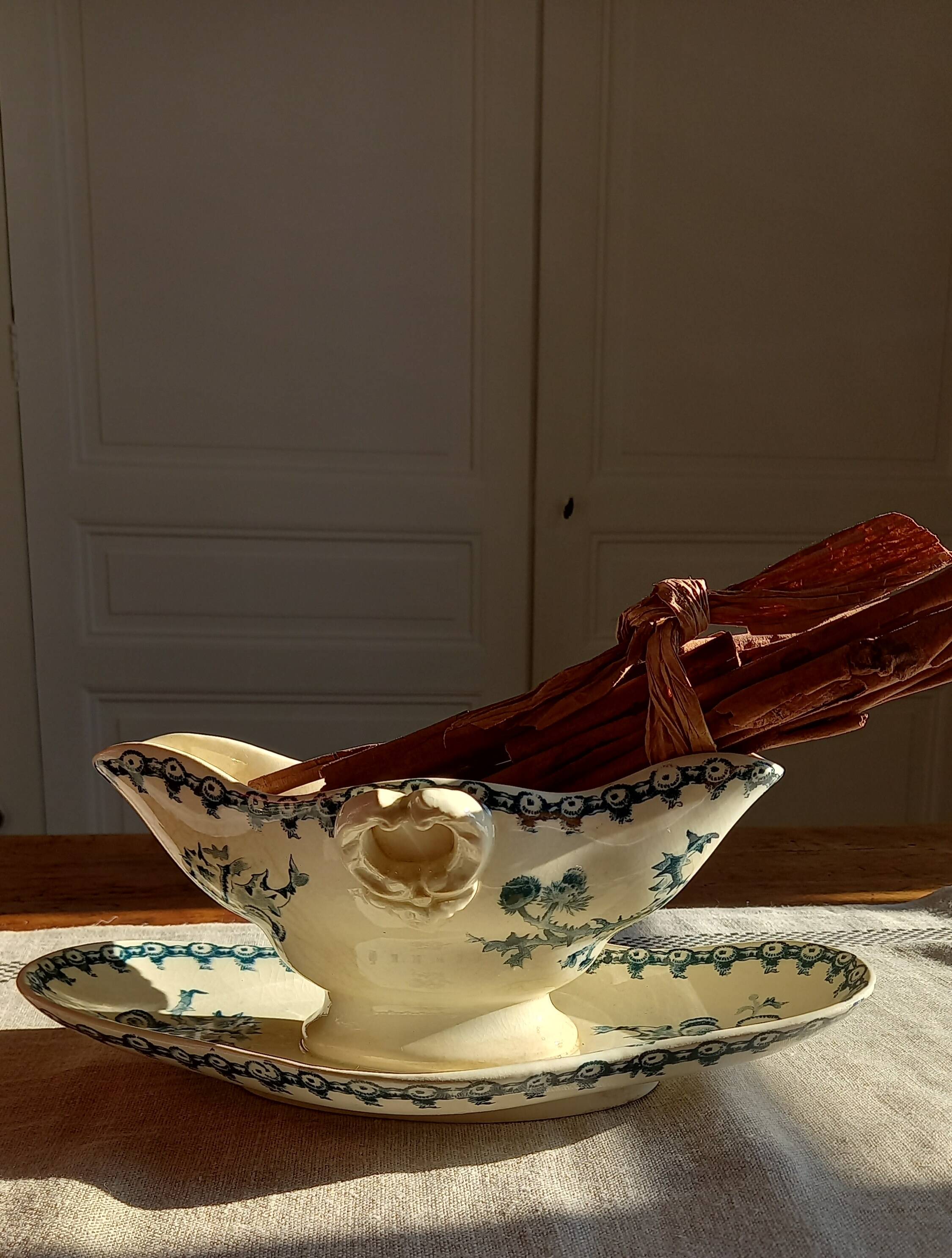 Old gravy boat on frame in terre de fer earthenware by gien, “chardons” model in blue-green