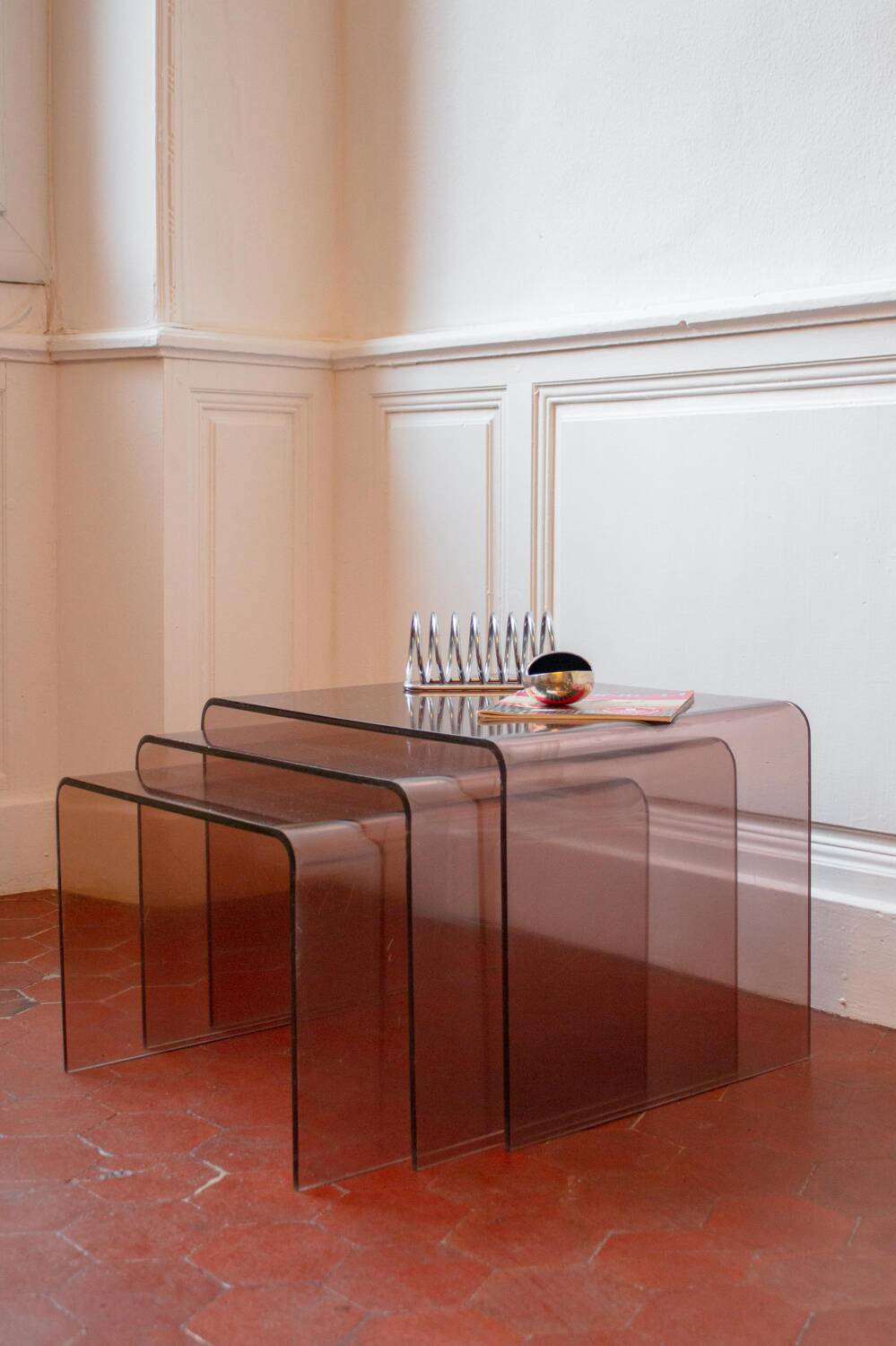 Vintage trio of nesting tables in smoked plexiglass by Michel Dumas, year.