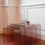 Vintage trio of nesting tables in smoked plexiglass by Michel Dumas, year.