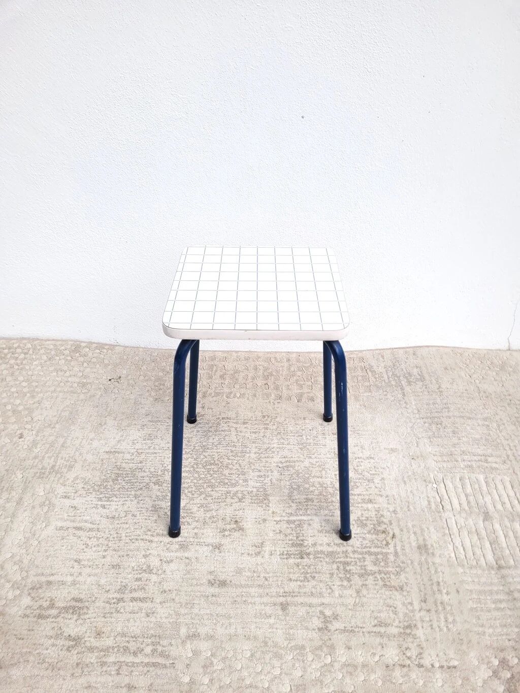 Vintage 80s melamine stool in navy blue checkered pattern.