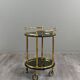 Rolling serving table in gold metal and smoked glass, 20th century