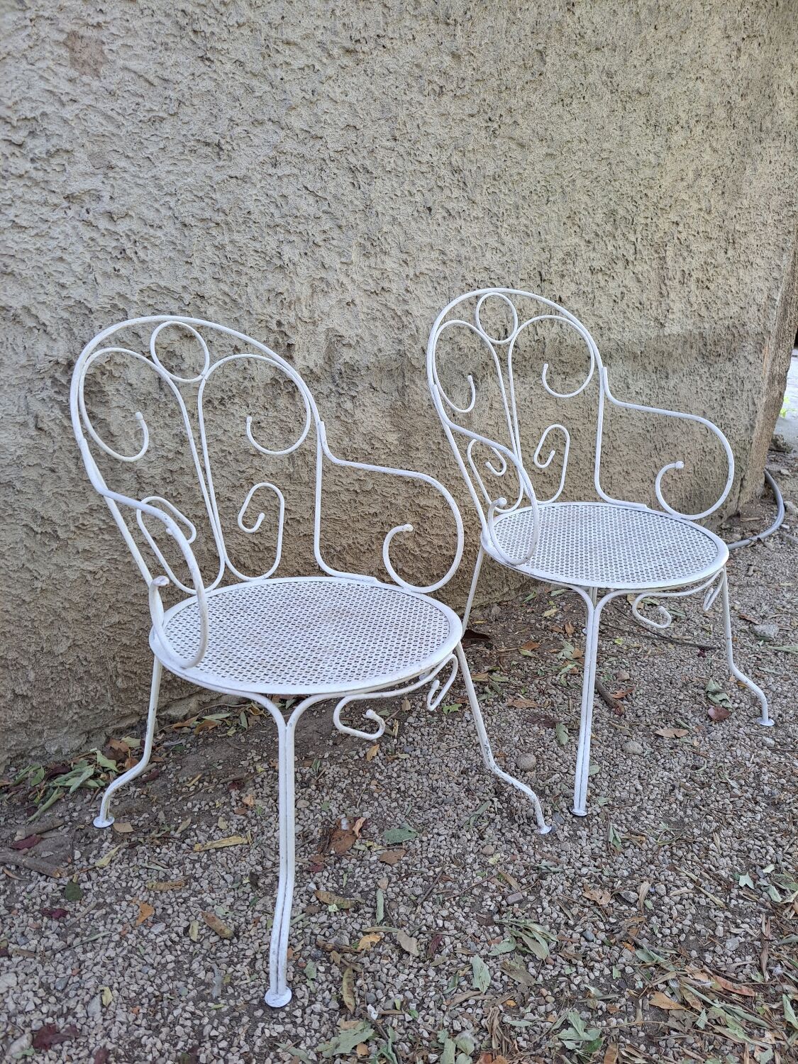 Pair of old white iron armchairs