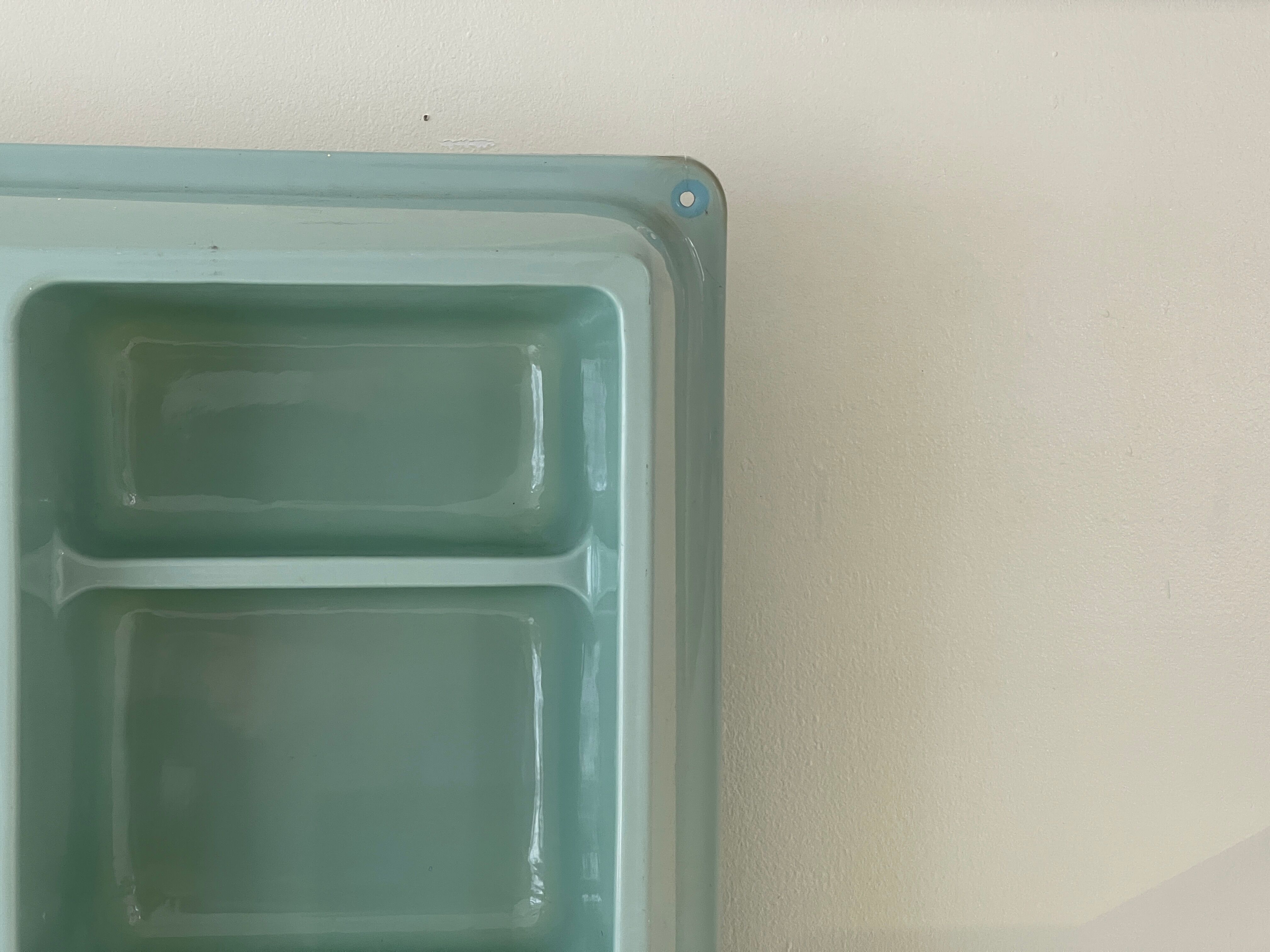 Baby blue plastic mirror and wash station