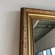 Gilded mirror with frieze h2m10 l:73cm