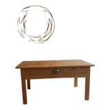 Coffee table with raw wood and a large drawer.