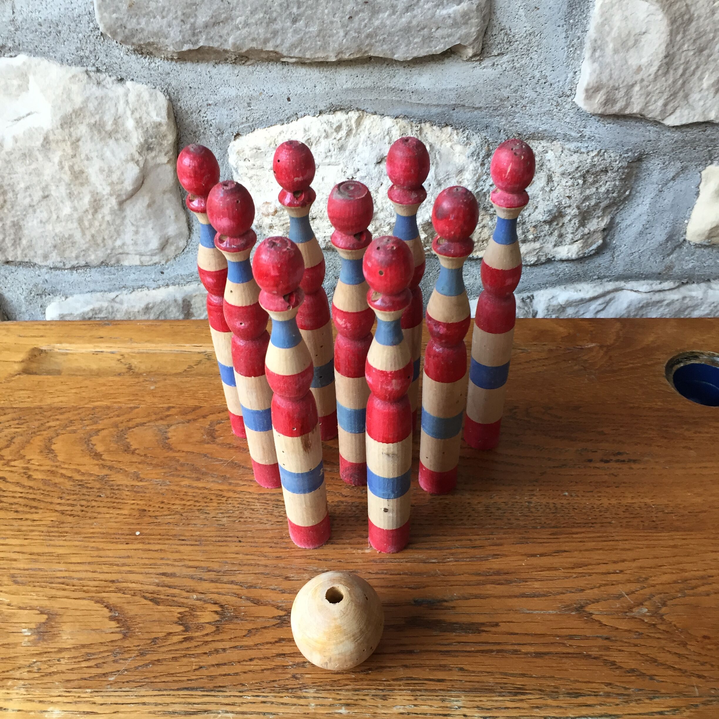 Former wooden tricolor bowling game with its ball