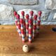 Former wooden tricolor bowling game with its ball