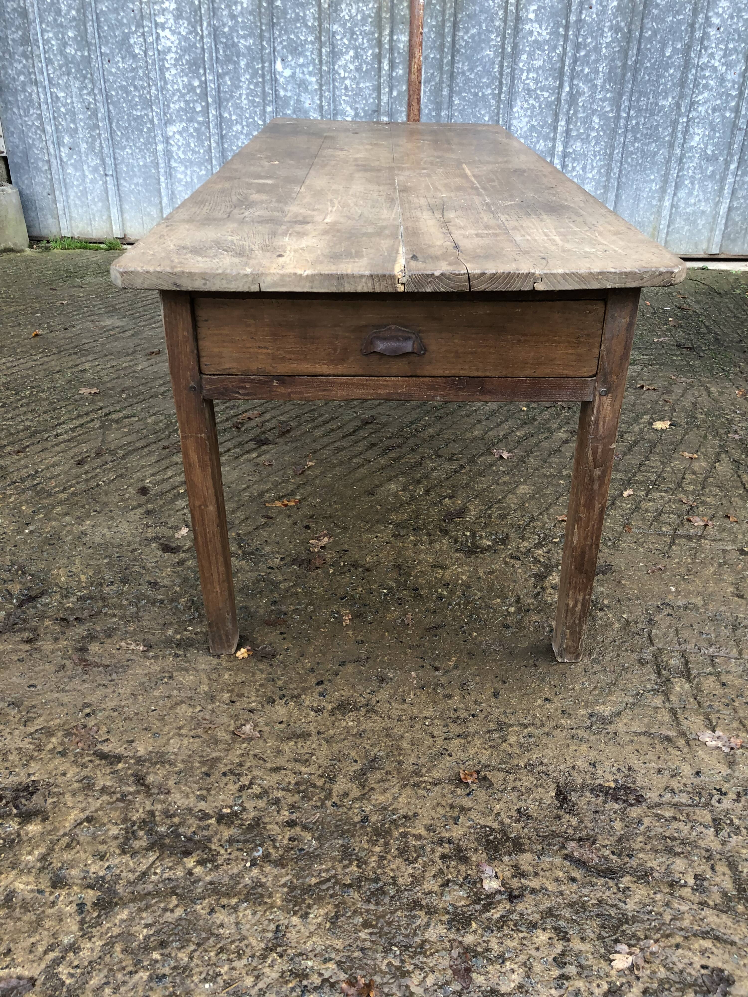 Antique farmhouse table in solid oak with tapered legs and 1 drawer at the end.