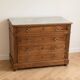 Antique wooden chest of drawers with a marble top.