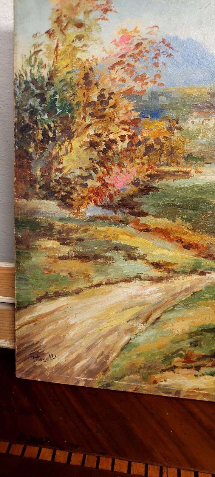 Oil painting on panel of a rural landscape, signed.