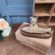 Vintage cat fish catchall in brass on a solid wood base.
