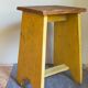 Art-populaire workshop stool in patinated painted wood