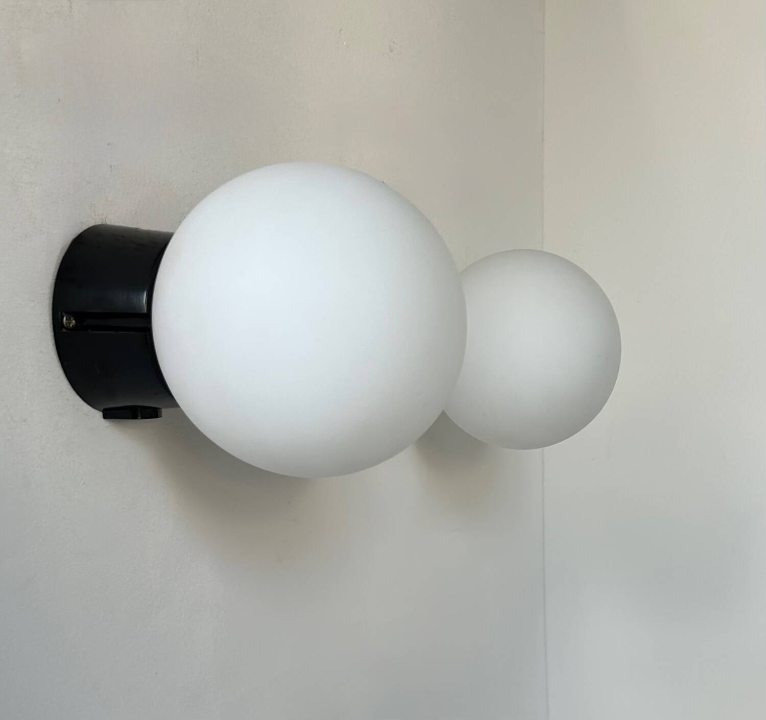 Pair of vintage Raak opaline and Bakelite wall lights, Netherlands 1970s