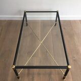 Brass coffee table upholstered in black leather. In the style of Jacques Adnet.
