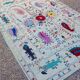 White suzani kilim rug with hand embroidered multi-colored patterns