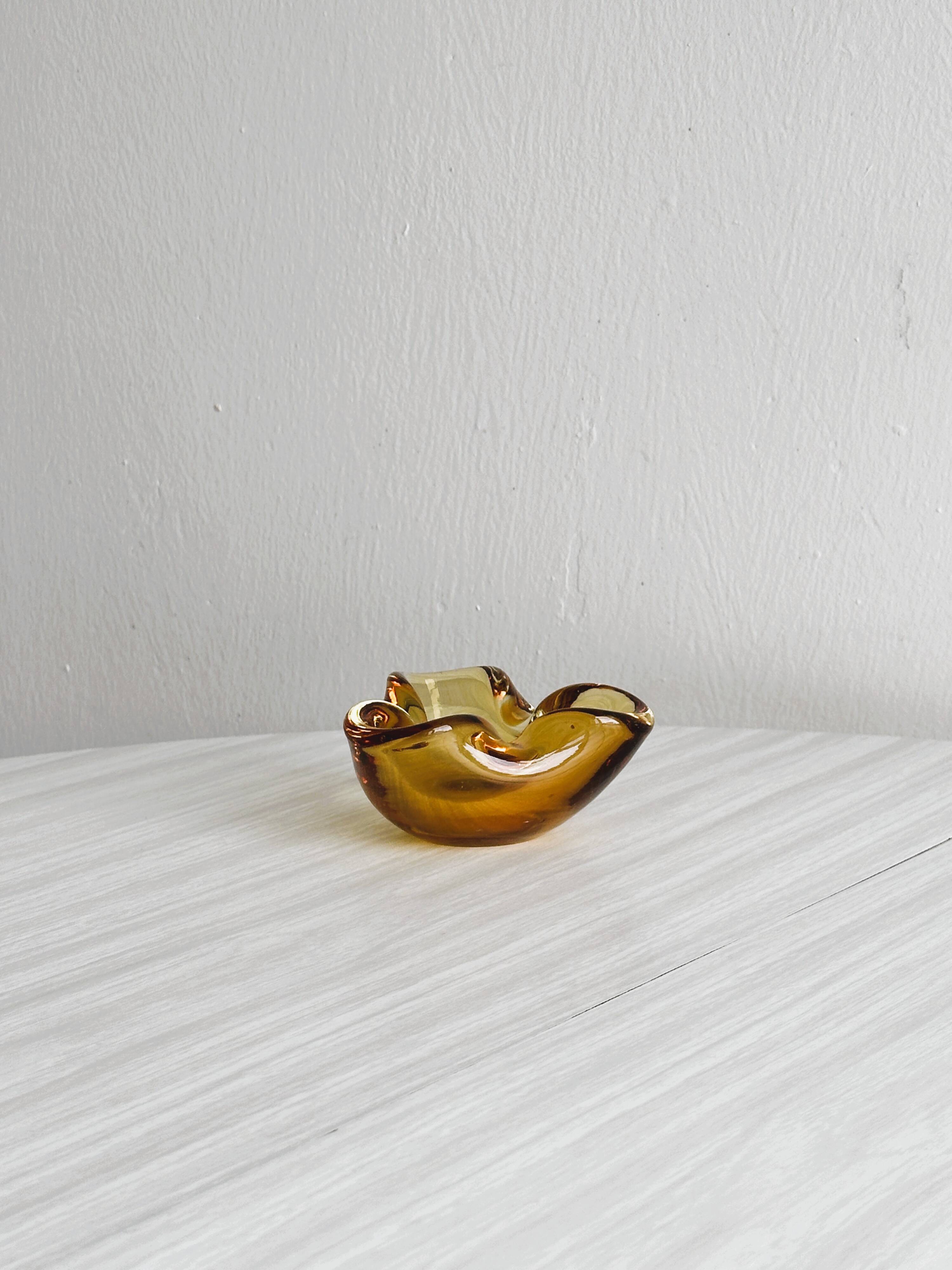 Thick amber yellow glass ashtray
