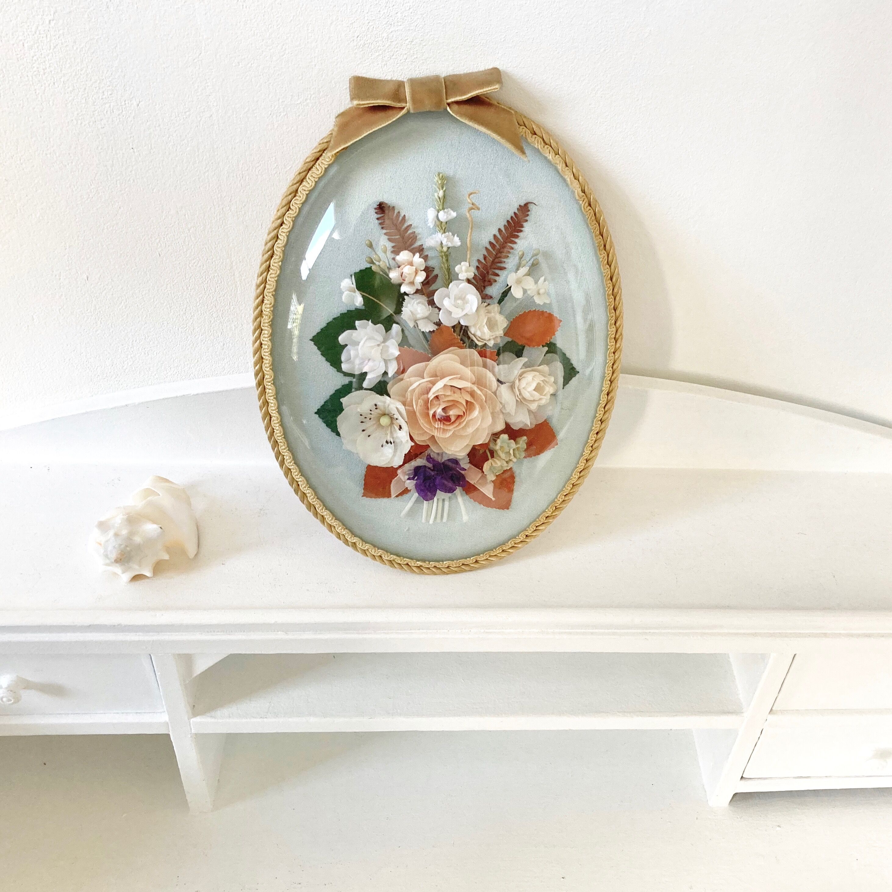 Frame domed glass flowers in fabric