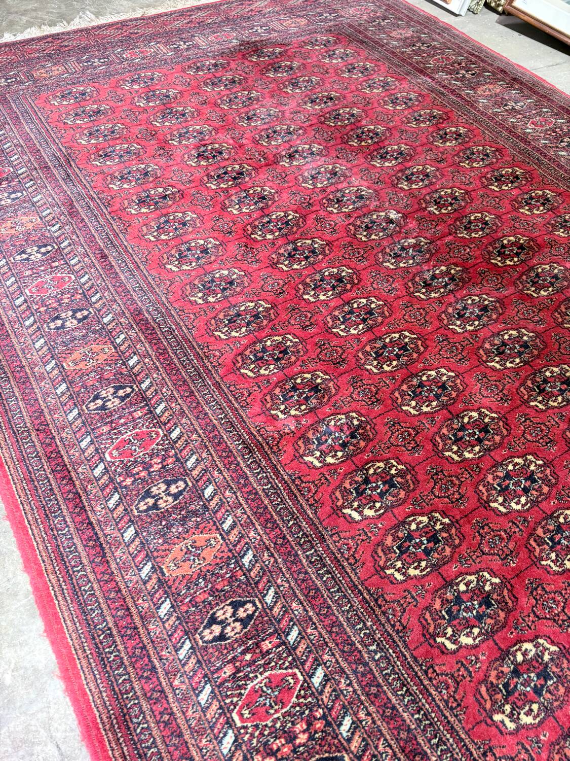 Large red Bokhara-style oriental carpet 300x200 cm with gul patterns.