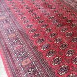 Large red Bokhara-style oriental carpet 300x200 cm with gul patterns.
