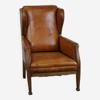 Unique cowhide wingback armchair with wooden details