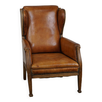 Unique cowhide wingback armchair with wooden details