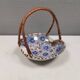 Beautiful small painted ceramic basket with woven handle