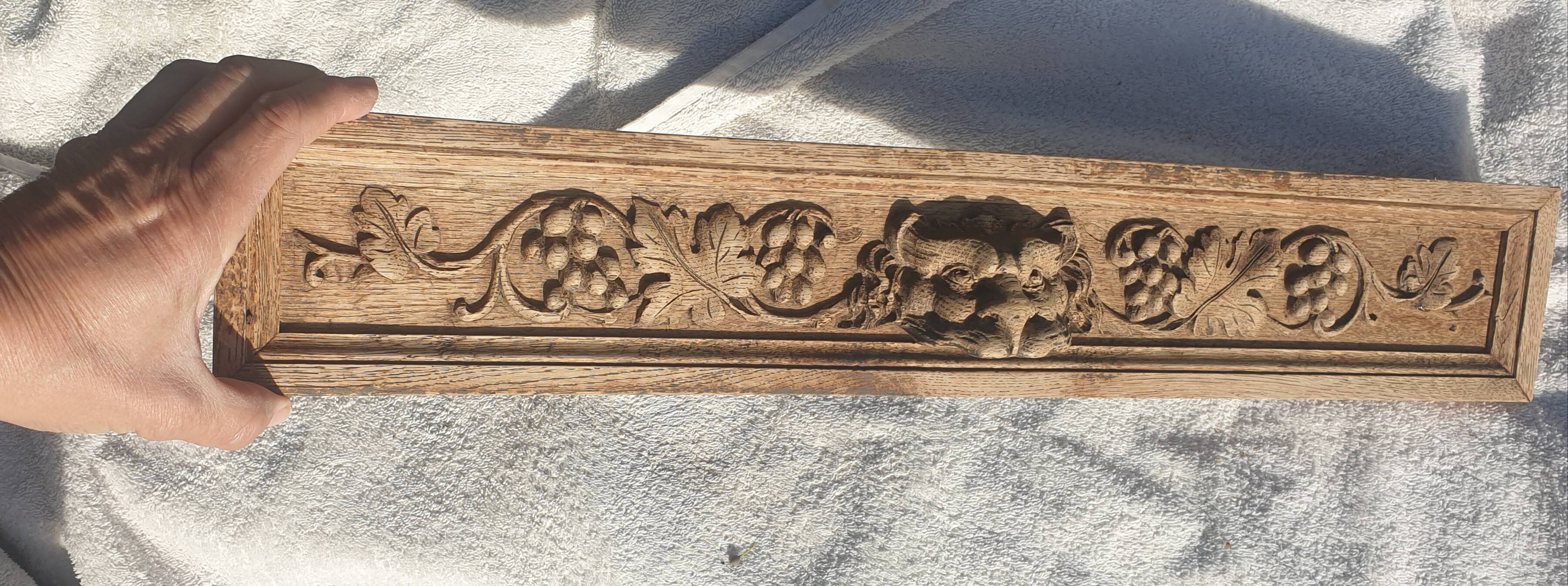Carved wooden pediment with bunches of grapes