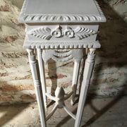 Carved wooden stool with a white patina.