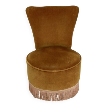 Ochre and fringed pouffe-style armchair