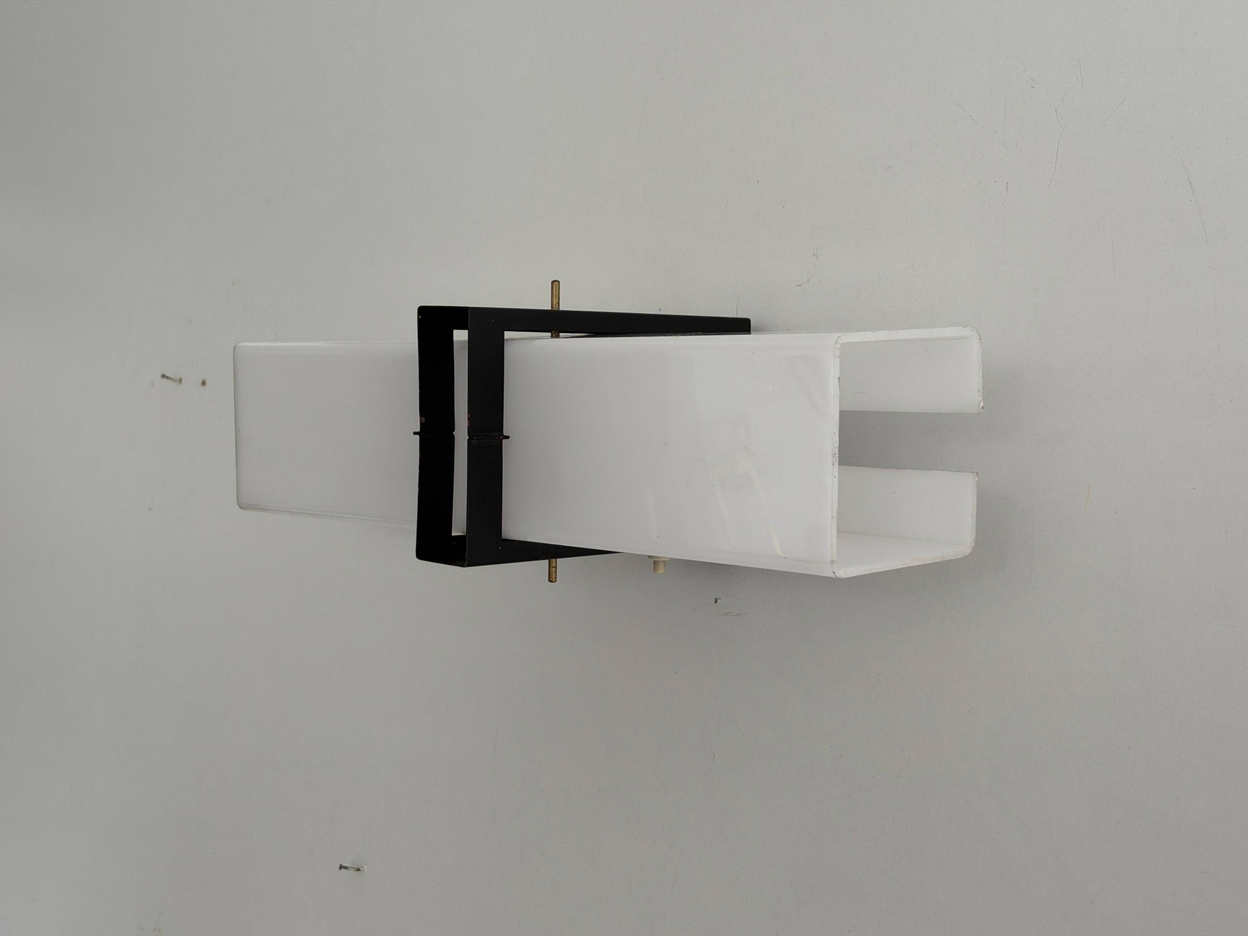 Simple white plexiglass wall light with a black metal frame, 1970s, Germany.