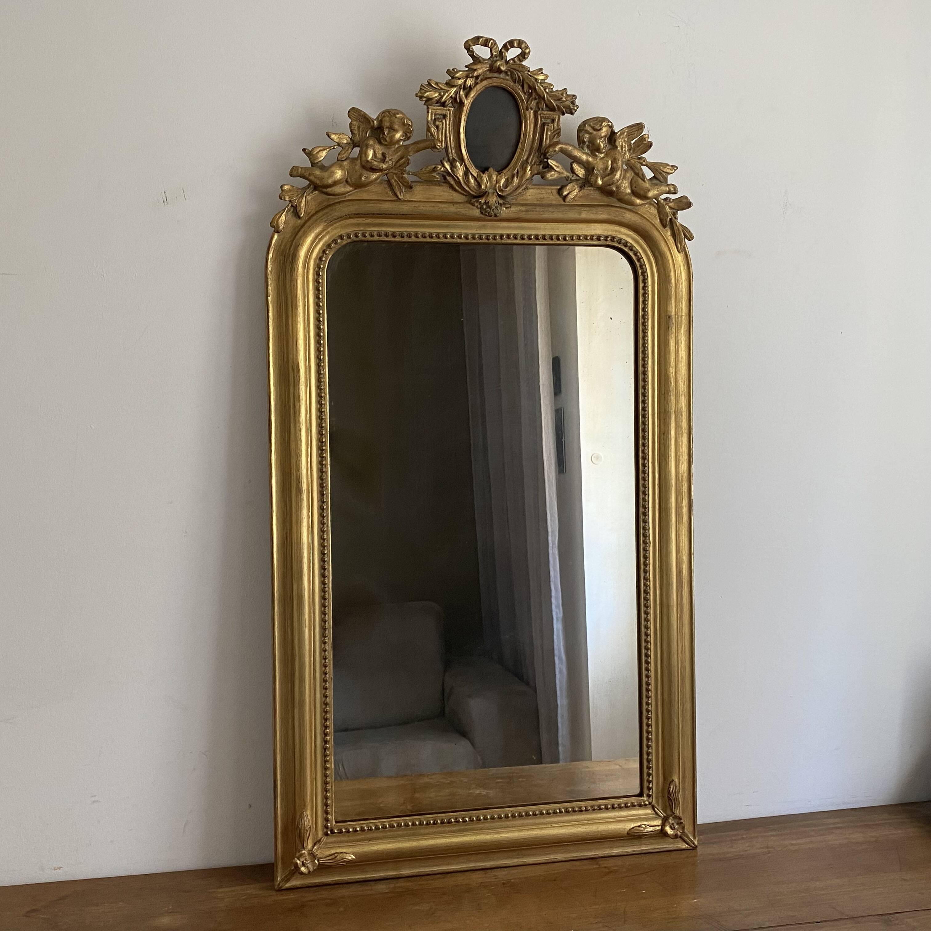 Late 19th century gilded mirror with decorated pediment. 125x70.