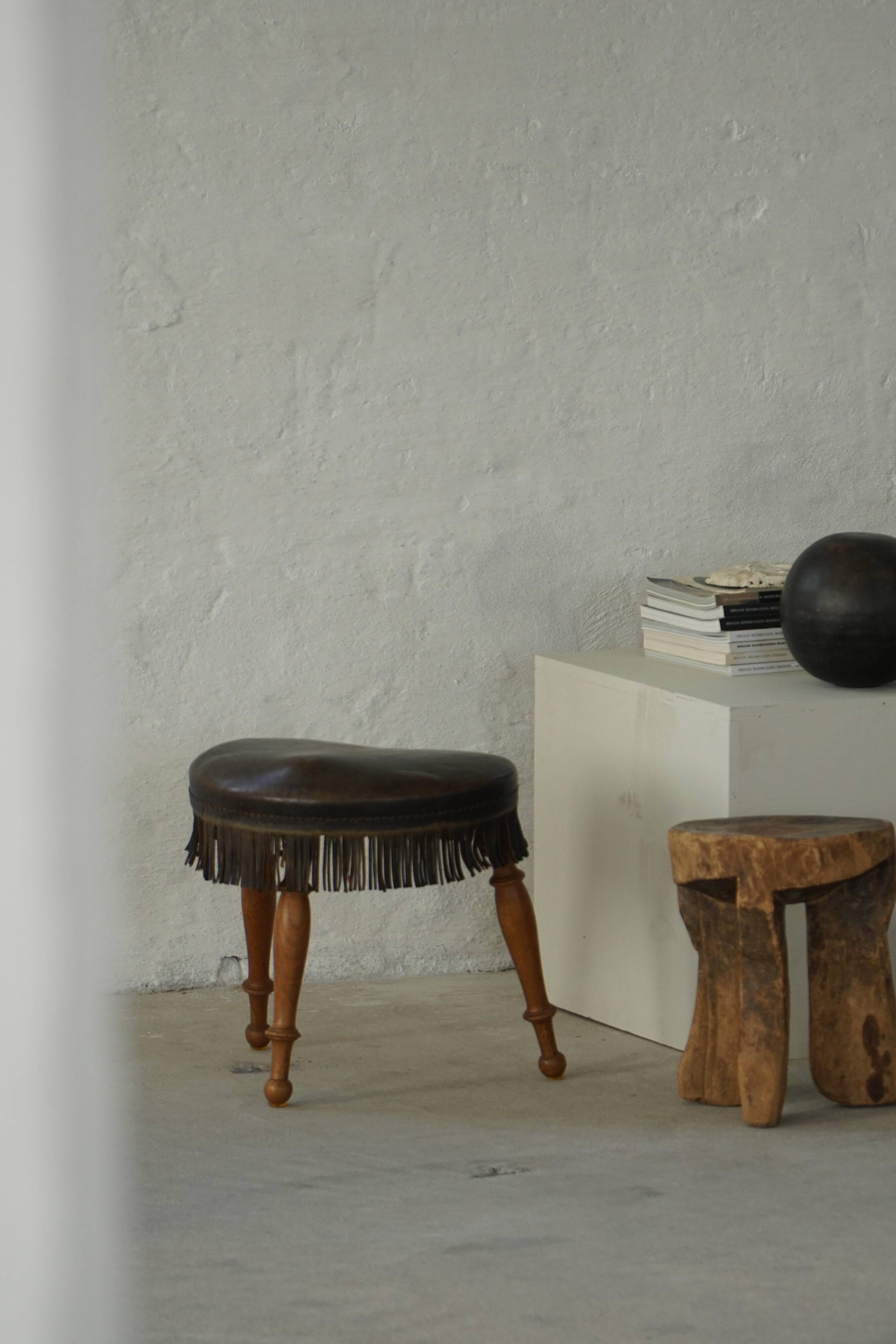 Danish oak tripod stool from the early 20th century with leather fringe, 1930s.