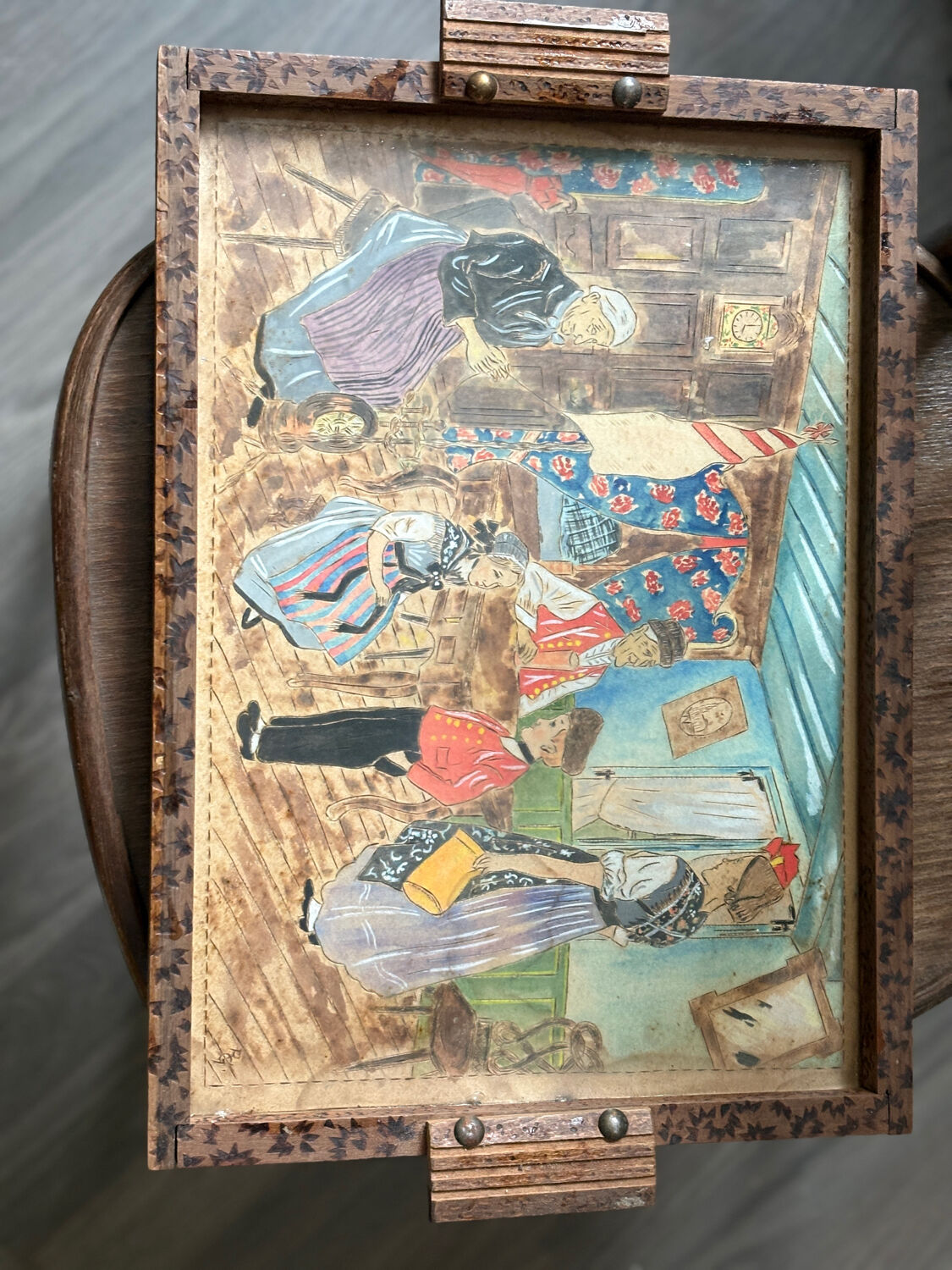 Antique wooden tray depicting a family scene