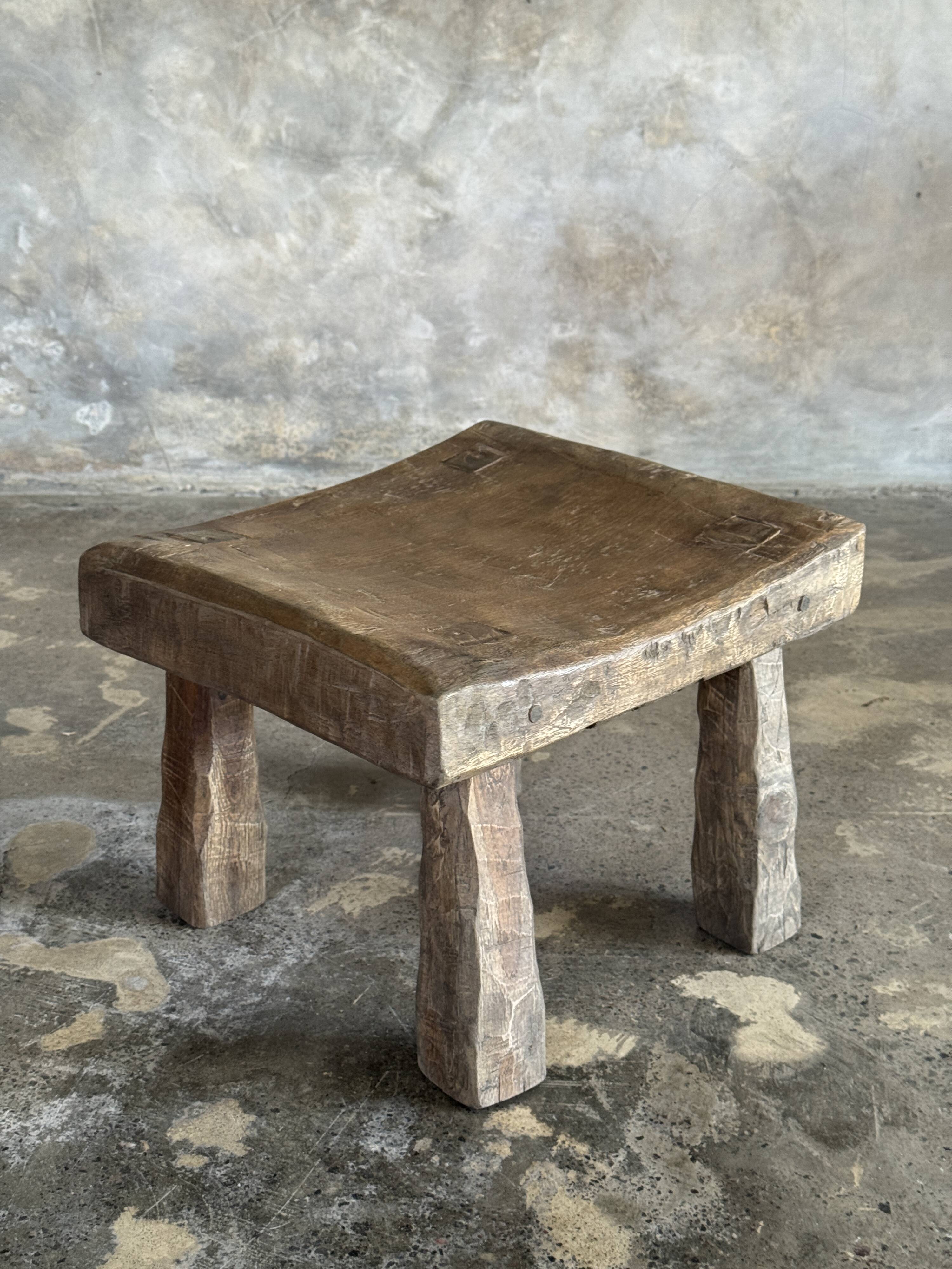 Small stool, square solid teak side table with a curved seat.
