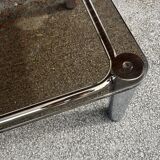 Vintage smoked glass coffee table with chrome structure.