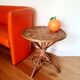 Old bamboo/rattan table with woven palm leaves.