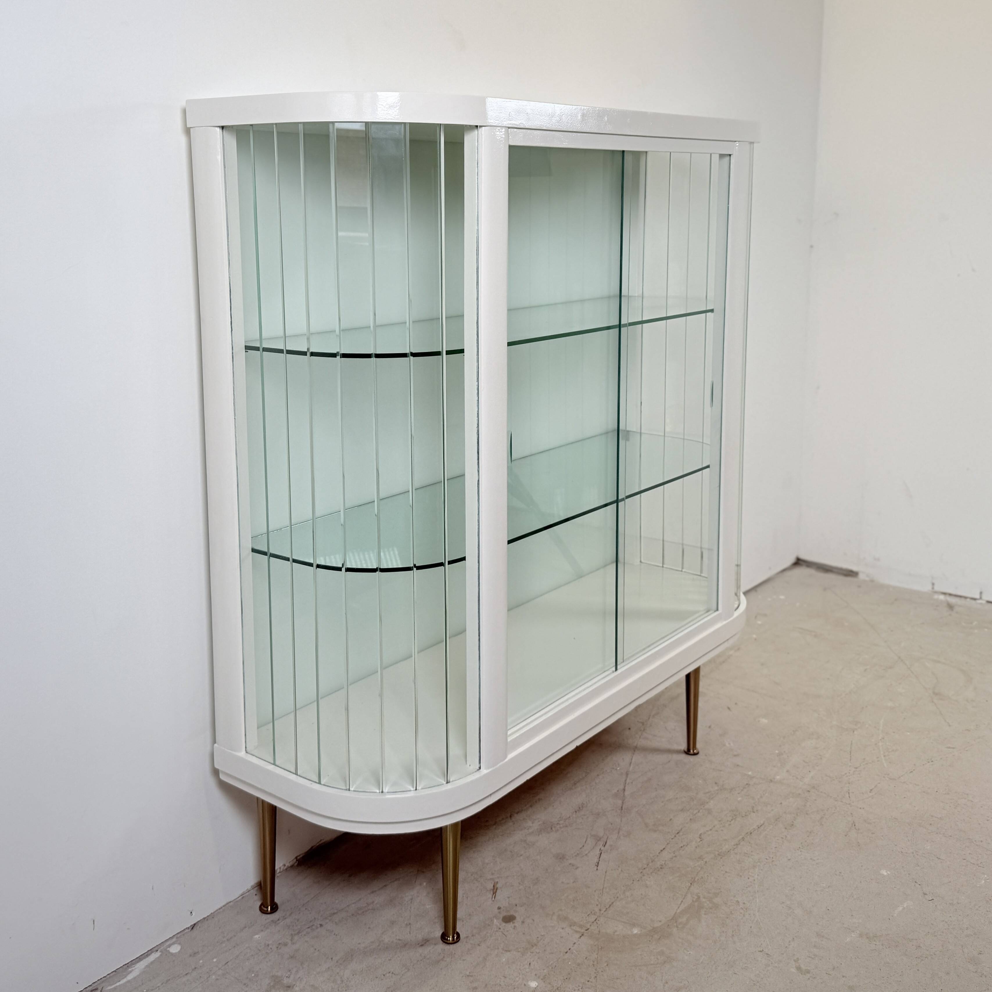 White vintage slatted display case on gold legs