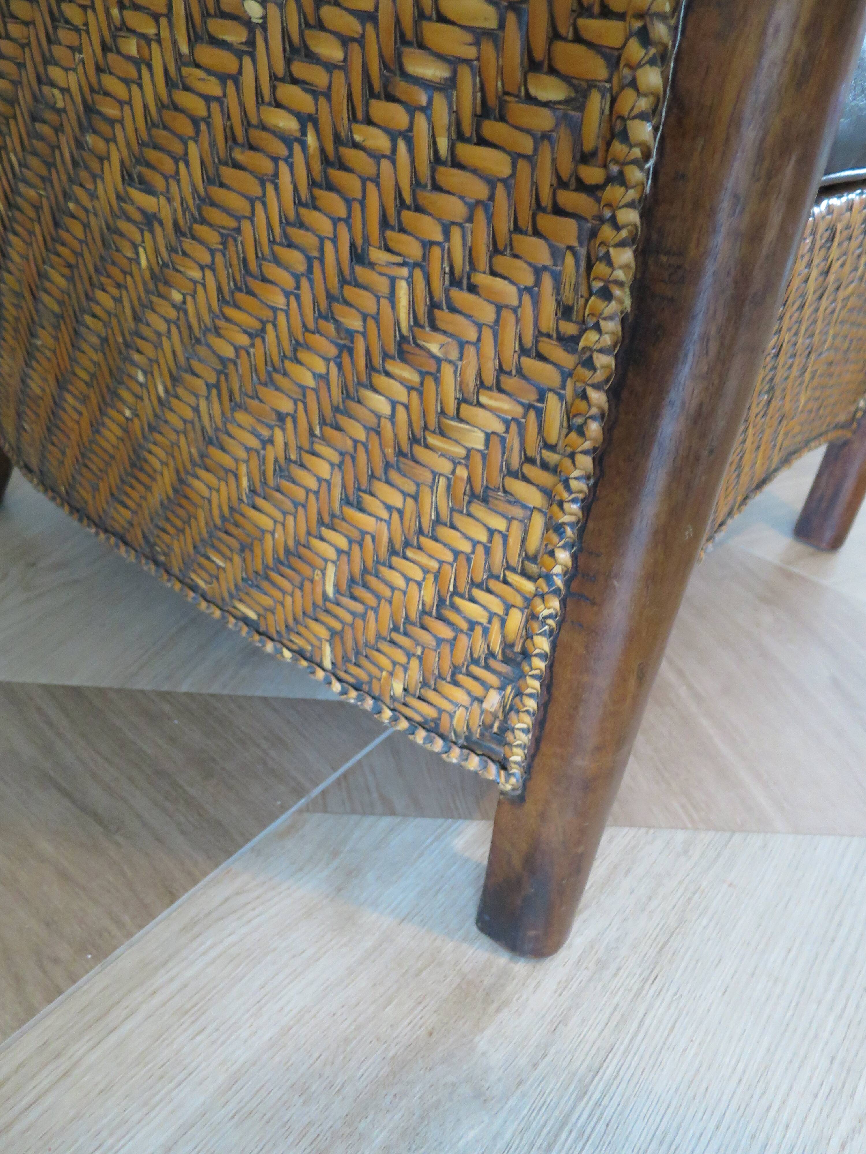 Colonial style armchair in woven rattan and exotic wood