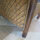 Colonial style armchair in woven rattan and exotic wood