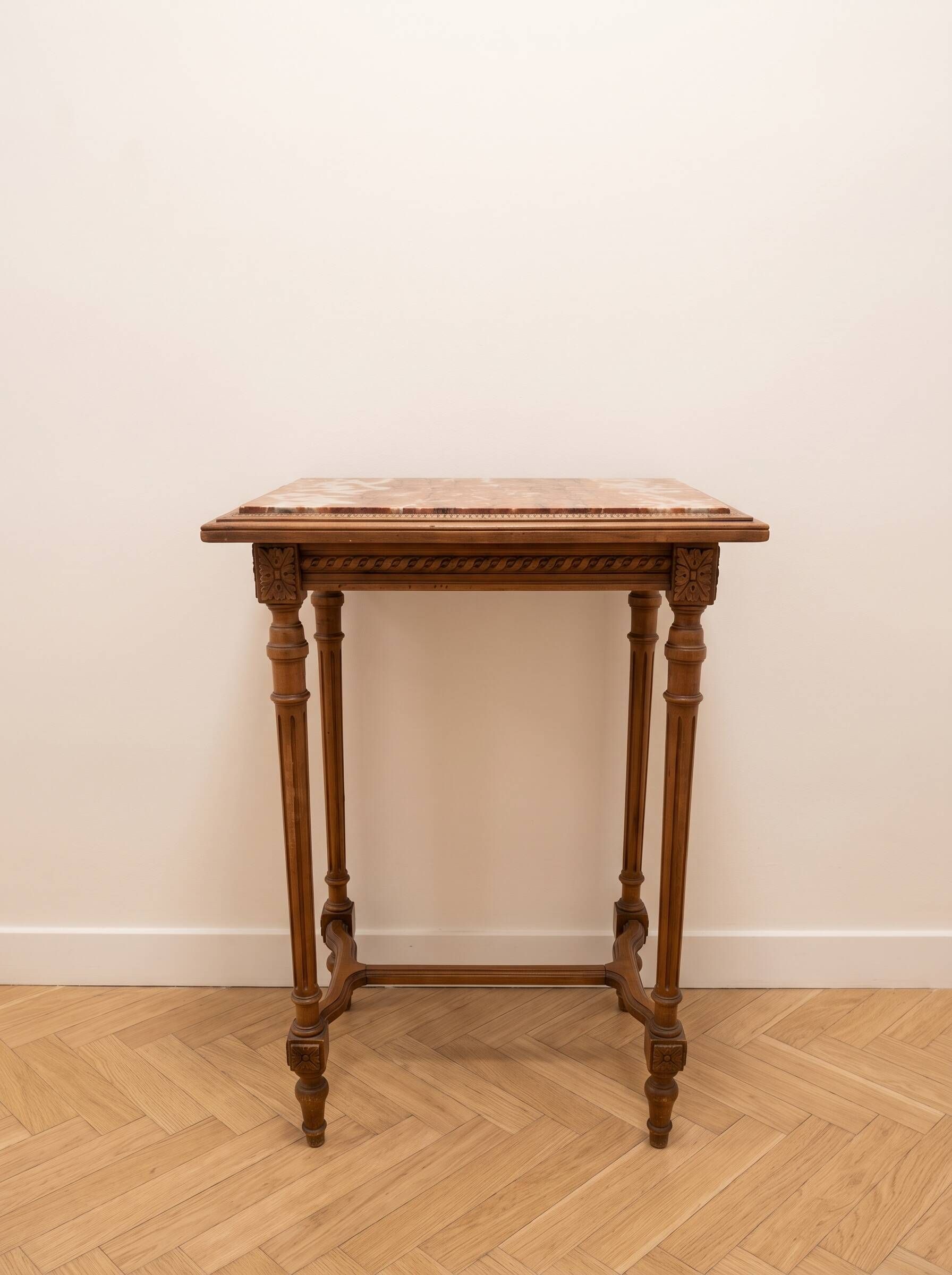 Classic wooden console with veined marble top.