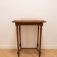 Classic wooden console with veined marble top.