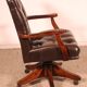 Office chair known as a director's chair in wood and tufted leather.