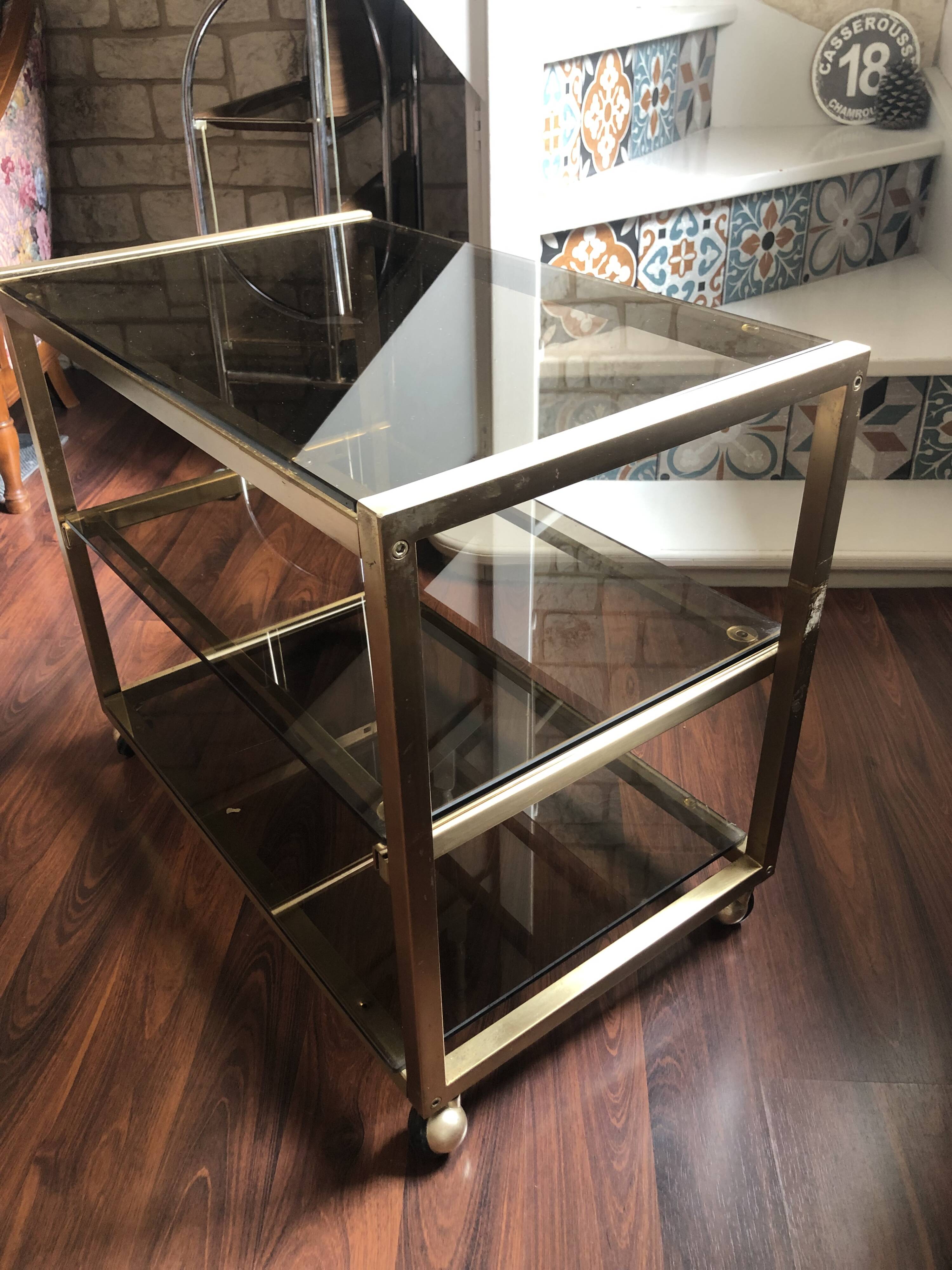 Vintage brass serving trolley with smoked glass trays.