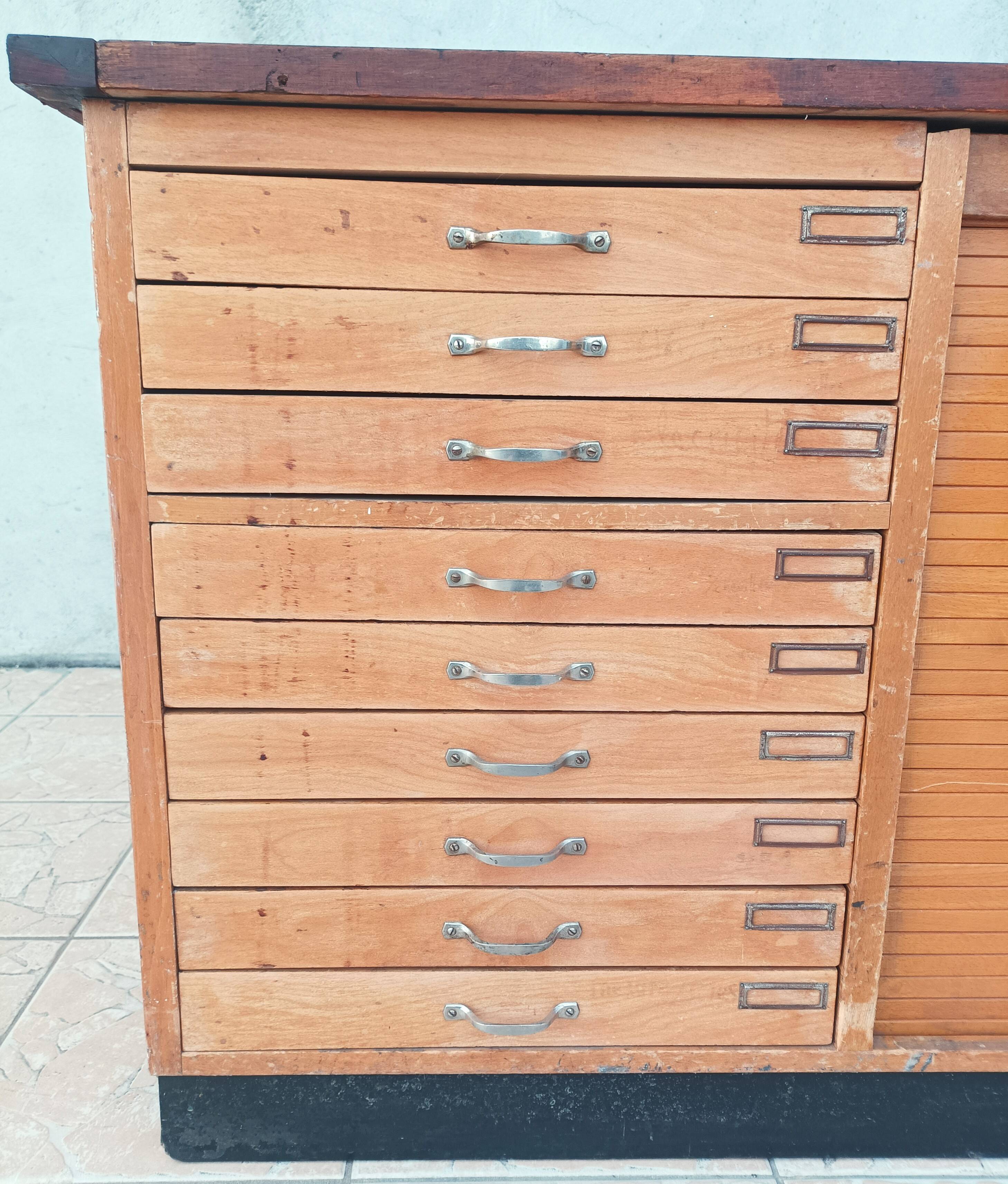 Workshop furniture with drawers and curtain in beech and walnut.